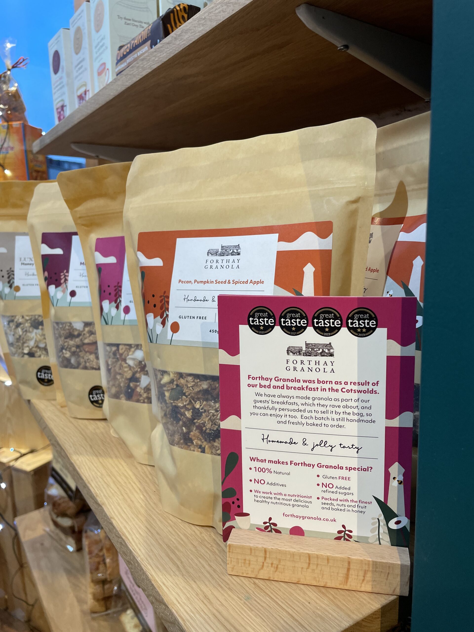 Bags of local produce on the shop shelves with a handwritten sign