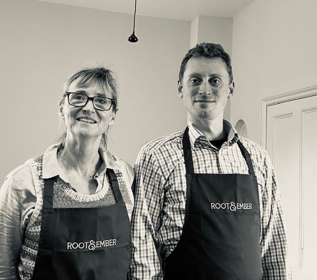 Two members of the Root & Ember family team in aprons, photographed in the shop