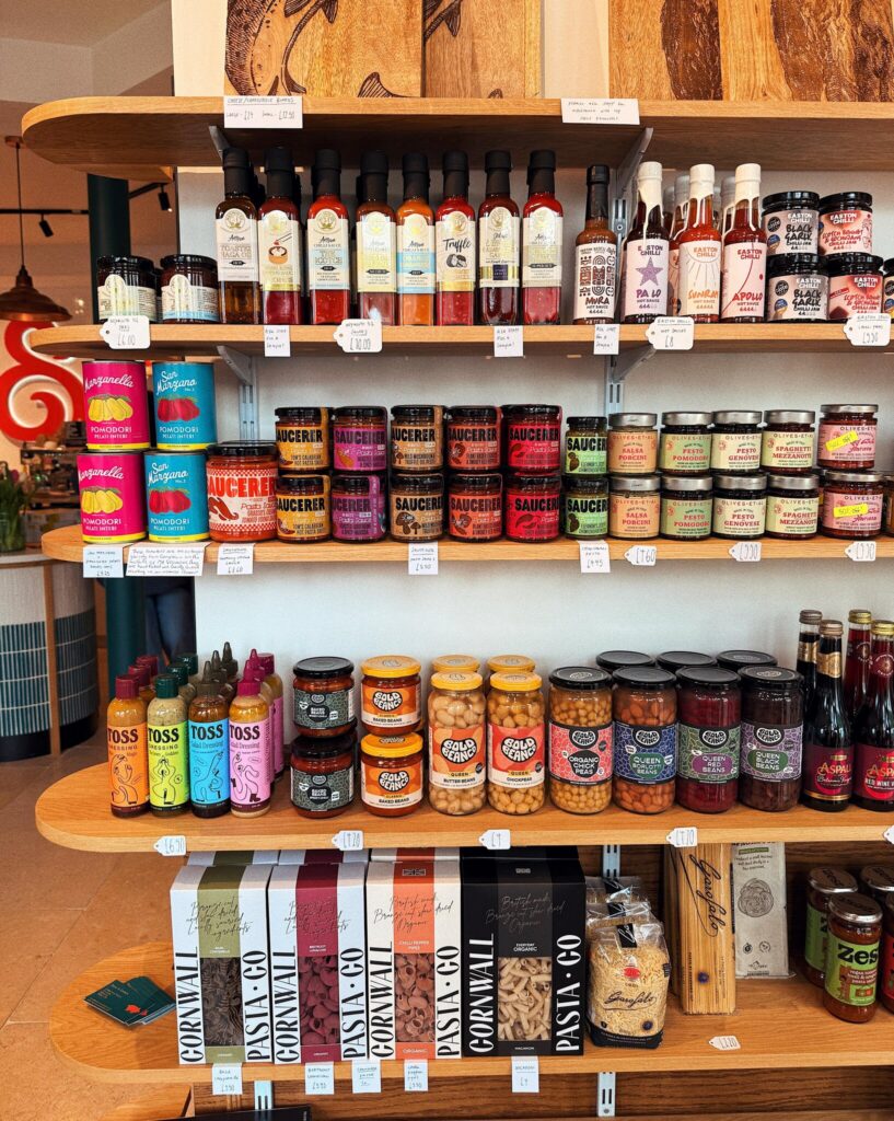 Shelves of sauces, preserves, beans and pasta in the Root & Ember shop